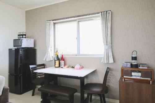 a kitchen with a table and chairs and a window at Itoman - House / Vacation STAY 7483 in Itoman