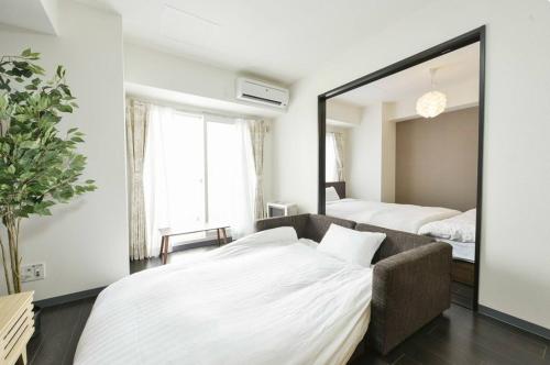 Ένα ή περισσότερα κρεβάτια σε δωμάτιο στο Suncourt Hongo Dori Garden Hills / Vacation STAY 7620