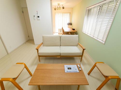 a living room with a coffee table and two chairs at Kinugawa Station Front room A in Nikko