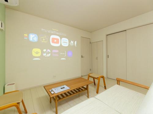 a room with a table and a large screen at Kinugawa Station Front room A in Nikko