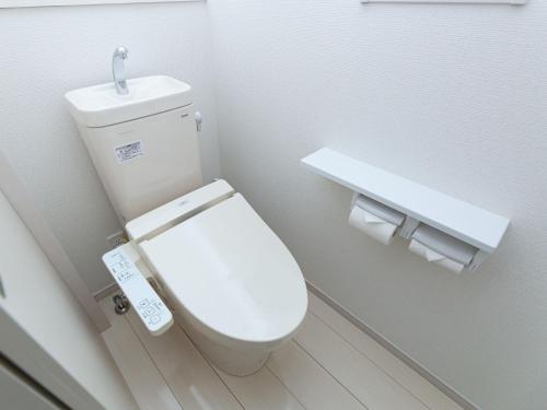 a bathroom with a white toilet and a sink at Kinugawa Station Front room A in Nikko