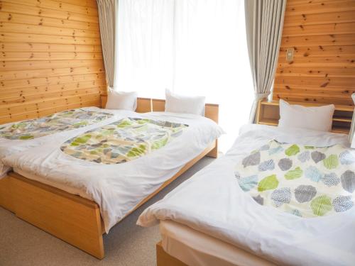 two beds sitting next to each other in a room at Nasu-gun - House - Vacation STAY 7648 in Nasu
