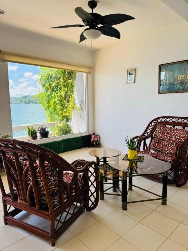 a living room with a couch and a window at Tikal Sunrise House in Flores