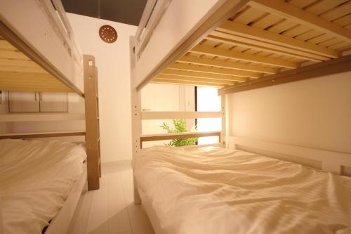 a bedroom with two bunk beds and a window at Minamitsuru-gun - House - Vacation STAY 82298 in Fujikawaguchiko