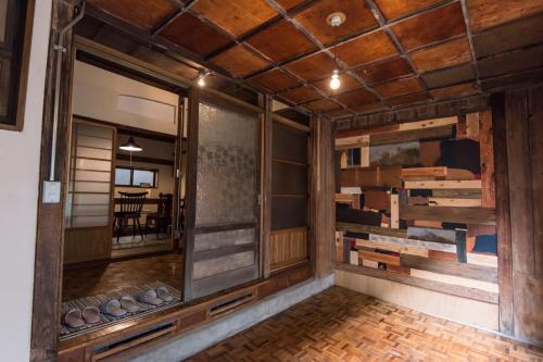 a room with wooden walls and a large mirror at DOT HOUSE NAGANO Traditional Japanese house - Vacation STAY 82102 in Nagano