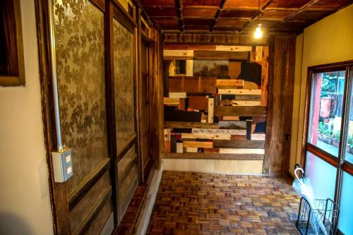 a hallway with a door and a room with boxes at DOT HOUSE NAGANO Traditional Japanese house - Vacation STAY 82102 in Nagano