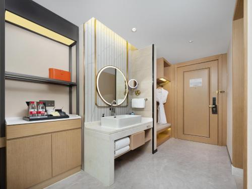 a bathroom with a sink and a mirror at Vienna International Hotel Xi'an Jinye Road Branch in Xi'an