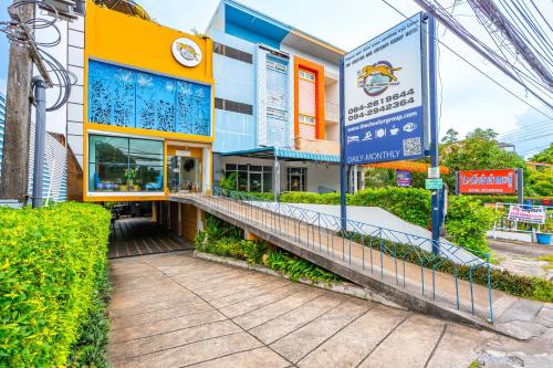 a building with a sign in front of it at The Cheetar Hotel in Amphoe Kathu