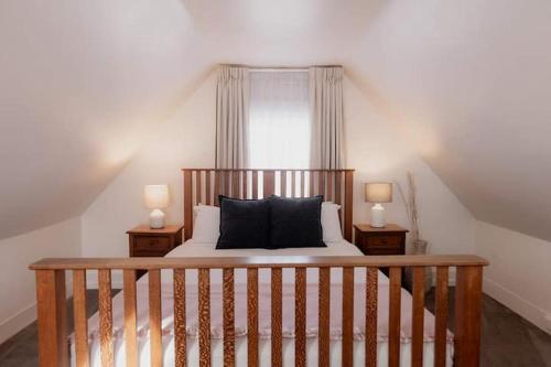 a bedroom with a bed with two night stands at Kelly Street Cottage in Historic Battery Point in Hobart