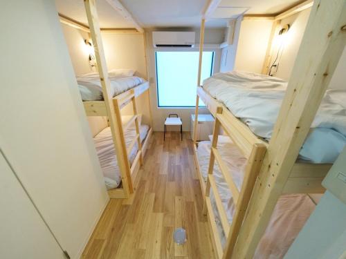 a room with four bunk beds in it at RetroSpect Stay Yokohama - Vacation STAY 99033v in Yokohama