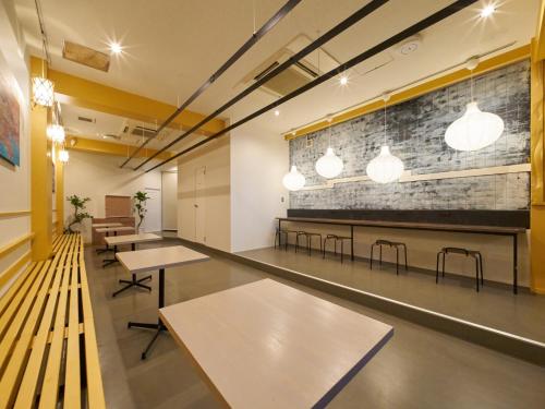 a room with tables and chairs and a brick wall at RetroSpect Stay Yokohama - Vacation STAY 99033v in Yokohama
