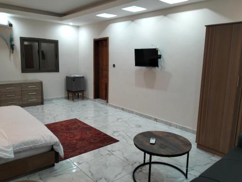 a bedroom with a bed and a tv on a wall at Baville in Iloneyon-Sekioni