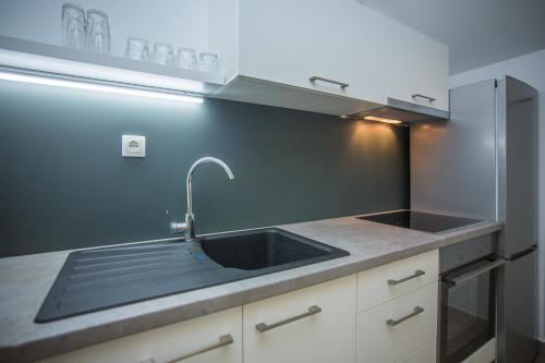 a kitchen with a sink and a counter top at Bozikovic 365 in Podstrana
