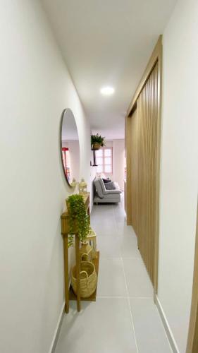a hallway of a house with a mirror and a table at Casa Julieta in Guatapé