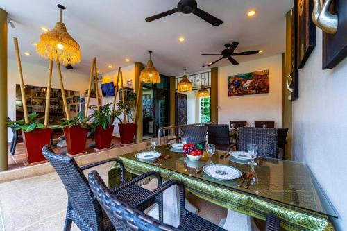 a dining room with a table and chairs at Siam Court Hotel and Resort in Bang Sare