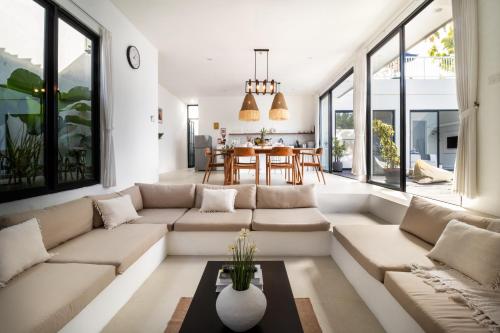 a living room with a couch and a table at Villa Casa More by BaliSuperHost in Ungasan