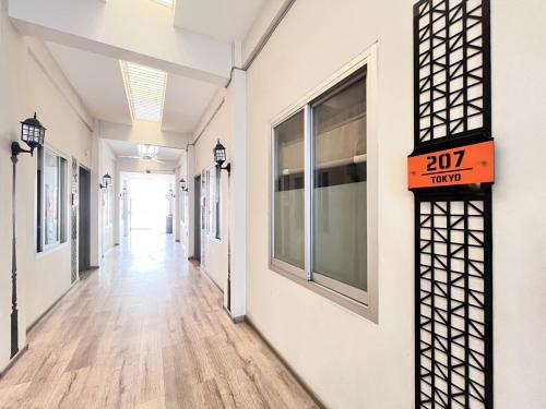 an empty hallway of a building with a sign on it at Sans Vibes Hotel Syariah Graha 100 Gubeng Surabaya in Surabaya