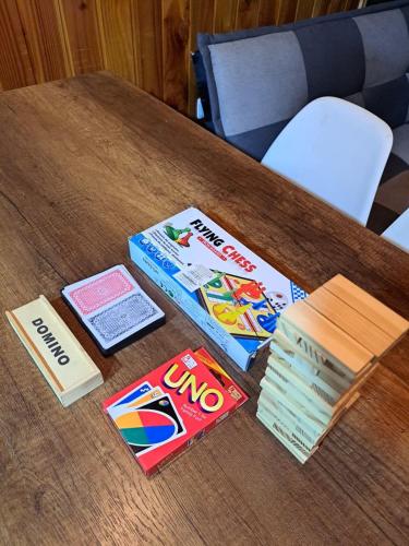 a wooden table with books and games on it at Cabaña Borde Río para 6 in Licán Ray