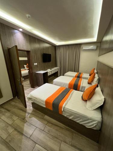 a hotel room with two beds and a bathroom at Sky Hotel in Aqaba