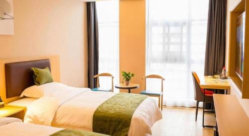 a hotel room with two beds and a desk and a window at GreenTree Inn Express Chuzhou Langya District Government Chuhe Road in Chuzhou