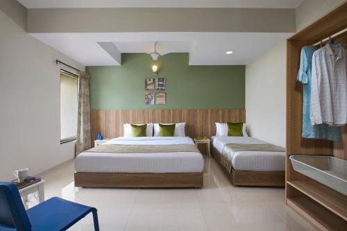 a bedroom with two beds in a room at Paprika Stays Panjim Donapaula in Panaji