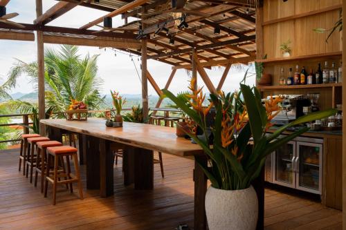 a kitchen with a large wooden table with a plant at Amaya Kampot Homestays in Kampot