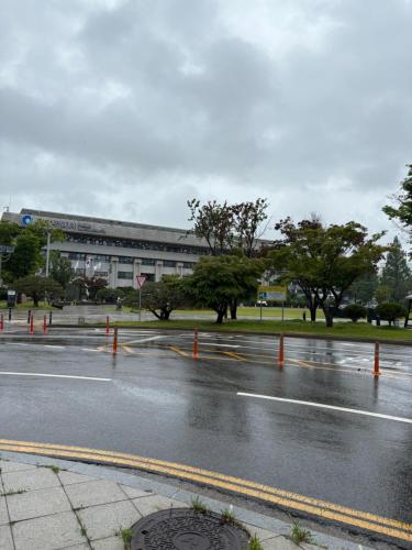 a wet street in front of a building at Sweet House Incheon in Incheon