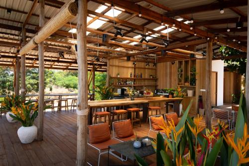 an outdoor kitchen with a bar and some plants at Amaya Kampot Homestays in Kampot