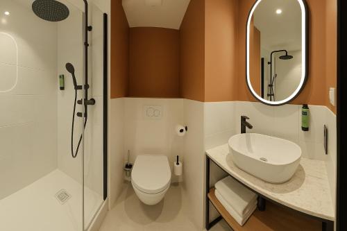 a bathroom with a toilet and a sink and a mirror at Logis Hôtel de Port d'Alon - St Cyr sur Mer in Saint-Cyr-sur-Mer