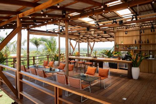 a patio with a bar and tables and chairs at Amaya Kampot Homestays in Kampot