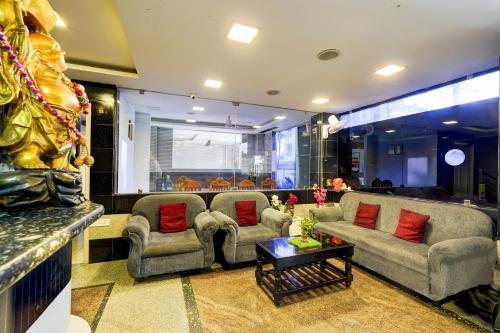 a living room with two couches and a table at Super Townhouse Balaji Dental College Pallikarani Formerly Orchid Sankrish in Chennai