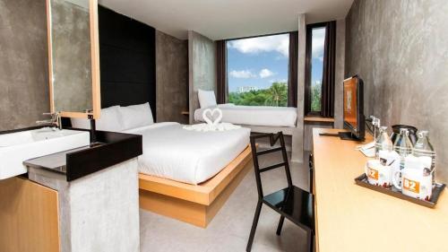 a bedroom with a bed and a bathroom with a sink at B2 Phuket Boutique & Budget Hotel in Patong Beach