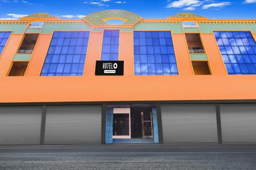 an orange building with a sign that reads whoo at Hotel O Rayagada Downtown in Rāyagada
