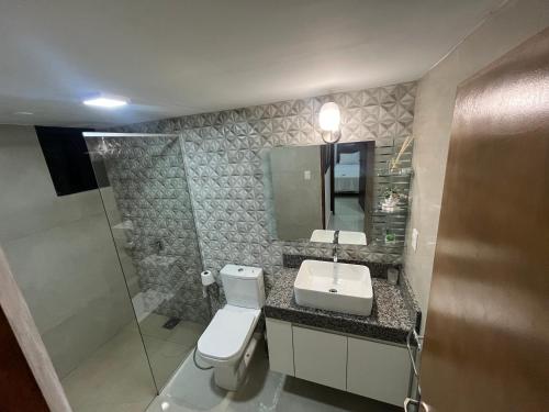 a bathroom with a toilet and a sink at Don Julio 1 in Encarnación