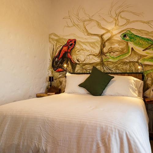 a bedroom with a bed with a headboard with two dinosaurs on it at Bellaphia Hotel Boutique in Filandia