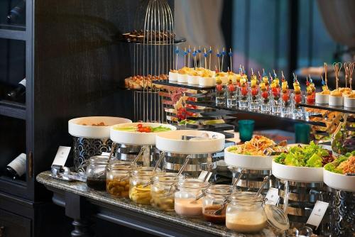 a buffet line with many different types of food at L'Heritage Premium Hanoi Central in Hanoi