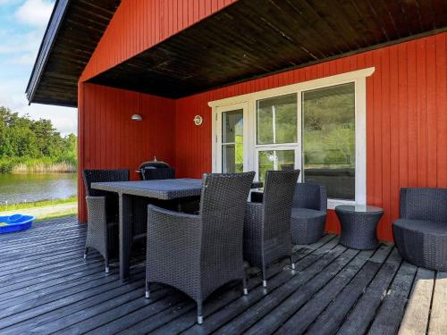a patio with a table and chairs on a deck at 4 person holiday home in Læsø in Læsø