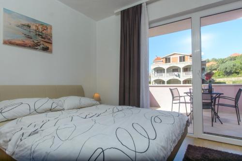 Ένα ή περισσότερα κρεβάτια σε δωμάτιο στο Apartmani MM