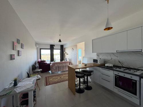 a kitchen and living room with a counter and a table at Nice Flat in Caesar in Iskele