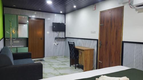 a room with a bed and a desk and a chair at Bell Farms and Resorts in Munroe Island