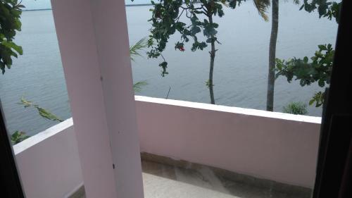 a view of the ocean from a window of a house at Orchid Lake View Homestay in Alleppey