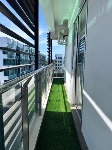 a balcony with a green floor on a building at Aeropod KK by D Hara Residence in Kota Kinabalu