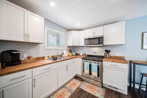a kitchen with white cabinets and a stove top oven at The Ultimate Lakewood Retreat! in Lakewood
