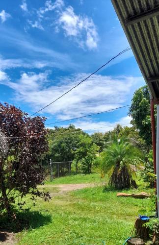 a view of a field from a house at Casa Rústica Rancho de Lía- Vacacional in Orotina
