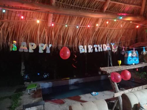 a party with a happy birthday banner and balloons at Casa Rústica Rancho de Lía- Vacacional in Orotina