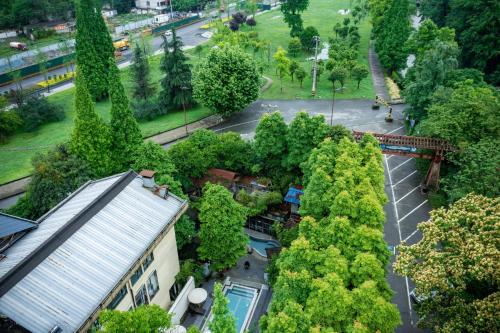 an overhead view of a park with trees and a building at Dujiangyan Irrigation Project Puruna Hot Spring Hotel Panda Valley Store in Dujiangyan