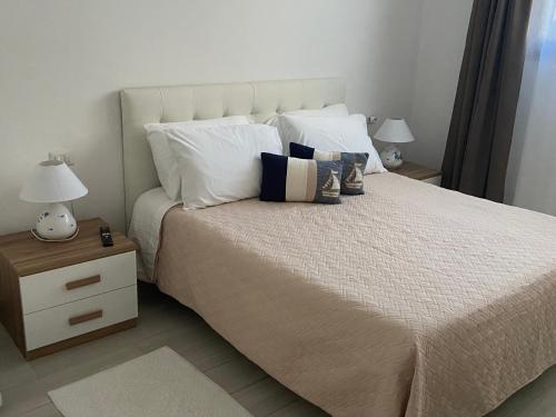a bedroom with a large bed with white pillows at Camelia's House in Olbia