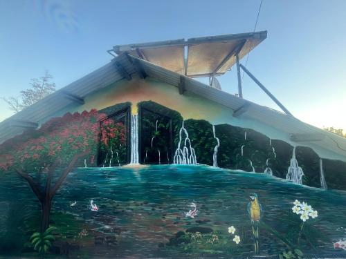 a painting of a house with a waterfall at Bungalow case Agathe in Bel Air