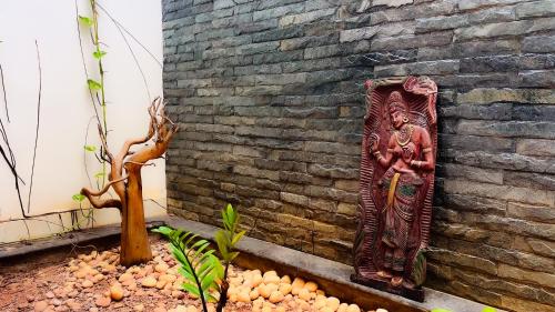 a statue on the side of a brick wall at Badhram Homestay 4bhk in Alleppey