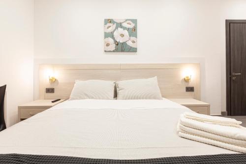a bedroom with a white bed with white sheets and pillows at Guesthouse No. 48 in Msida